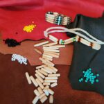 Pipe bone beads, coloured beads, and one finished bracelet and one unfinished bracelet made of these beads