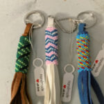 peyote stitch beaded leather keychains - multicoloured - tags are labelled Handmade With Love and a heart symbol