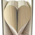 an open book with the pages folded toward the centre in a heart shap