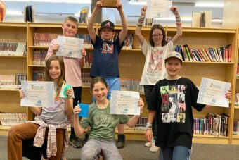 The Dust Bunnies of South Nelson Elementary display their 2024 Reading Link Challenge Award certificates