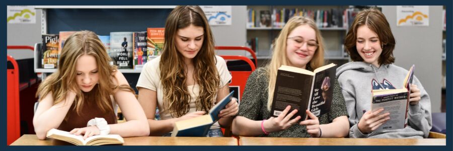 Teens book club reading books together in the LIbrary