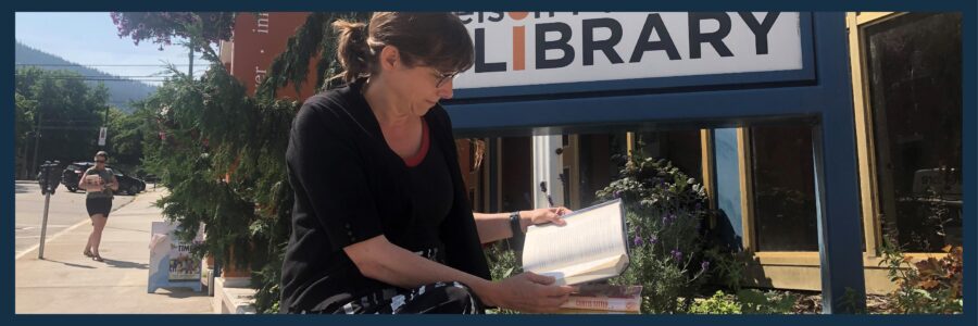 Woman reading outside of the LIbrary